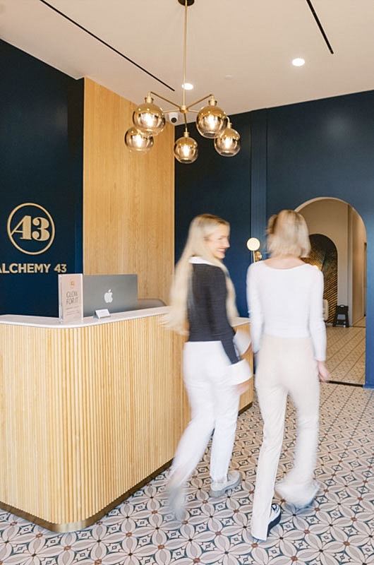 Women walking in a modern reception area.