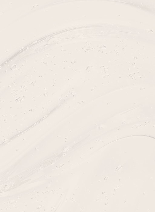Textured light cream background with water droplets.