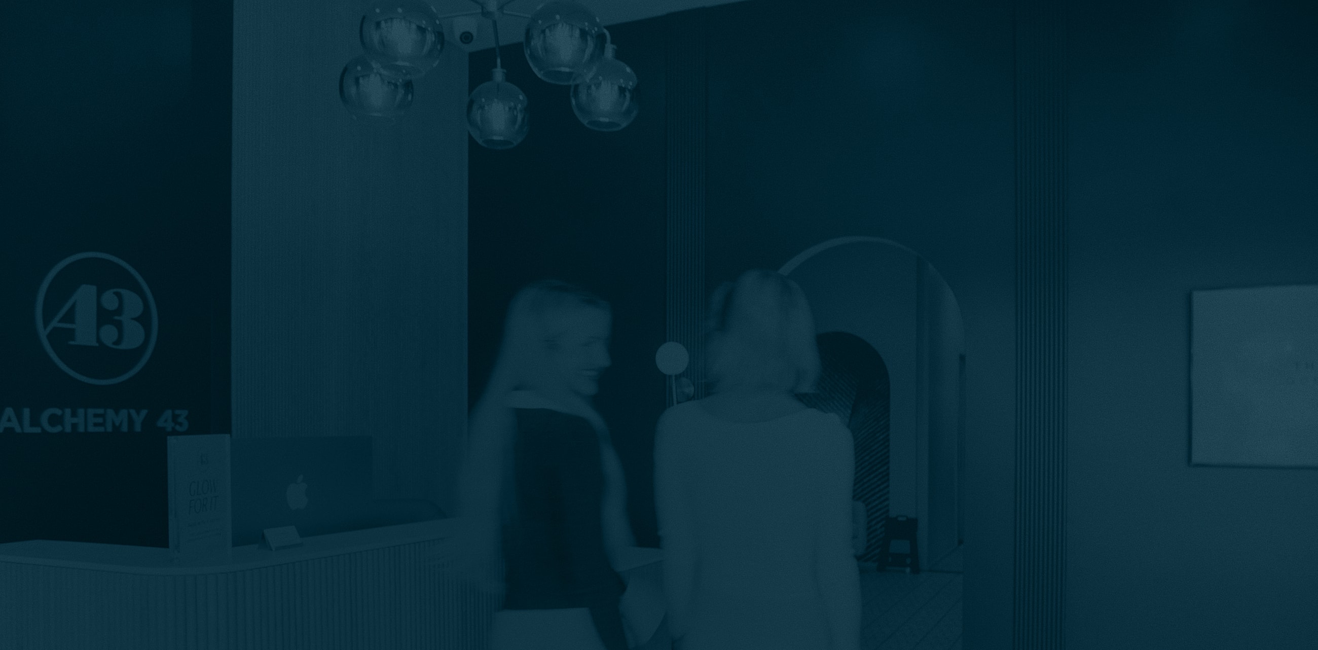 Two women walking in a modern interior.