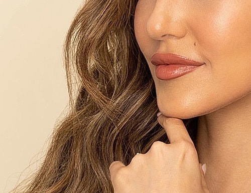 Close-up of woman's face with thoughtful expression.