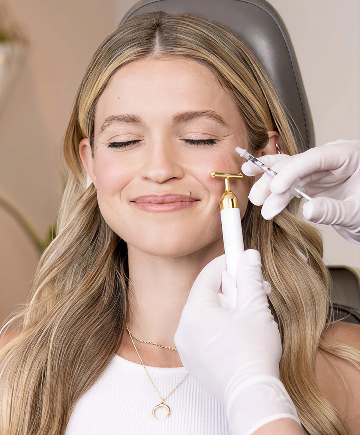 Injecting lip filler in a cosmetic procedure.