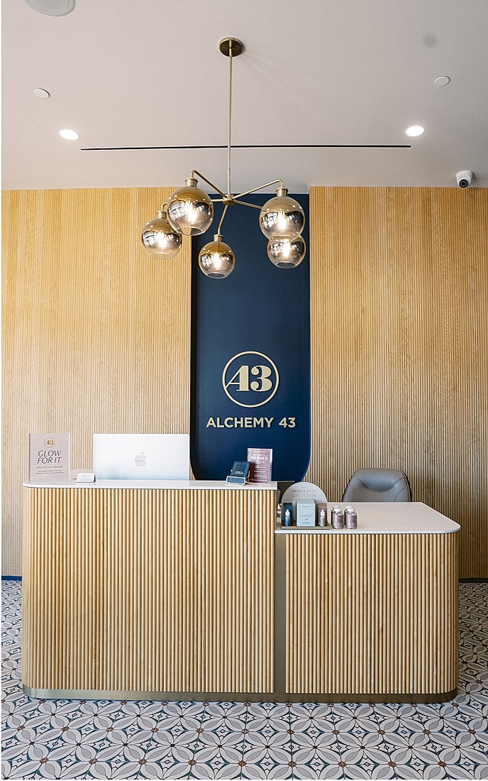 Modern reception area with Alchemy 43 branding.