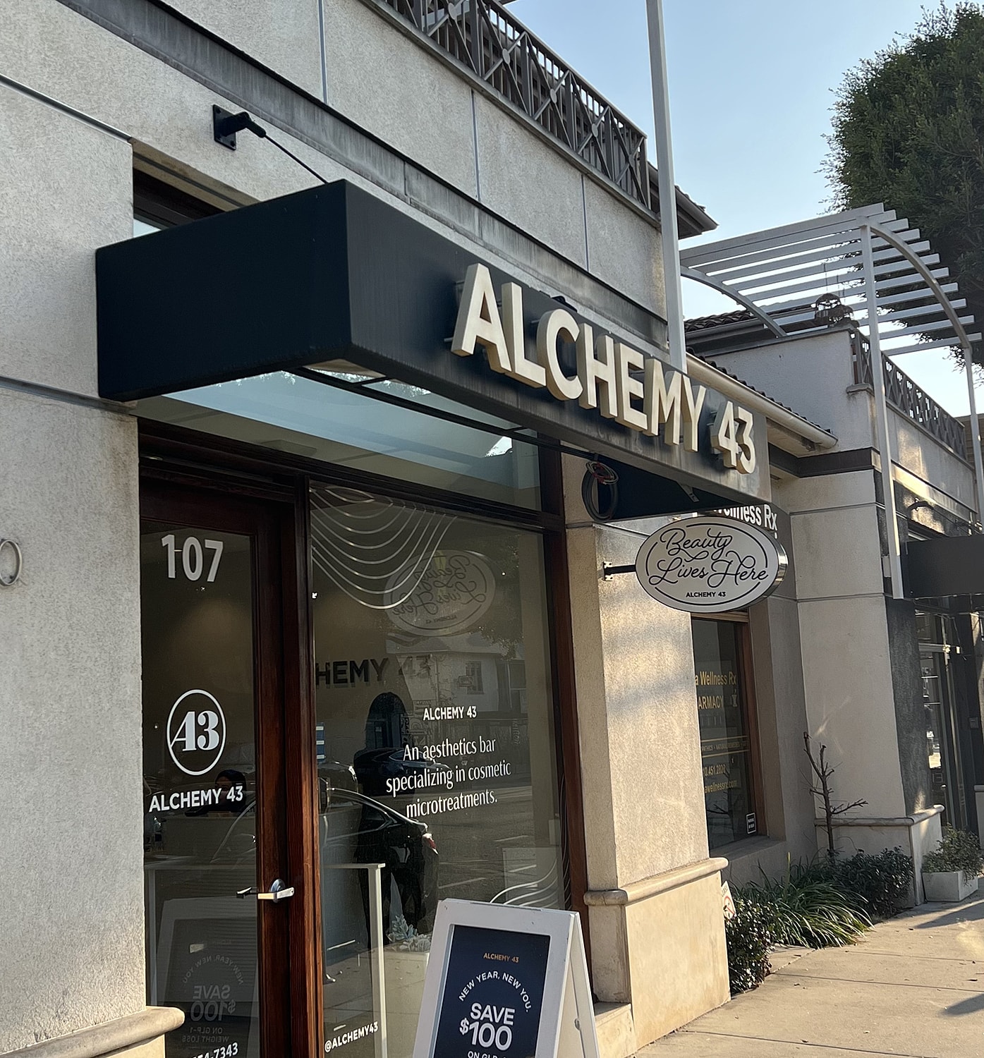 Signage for Alchemy 43 aesthetics bar and promotion.