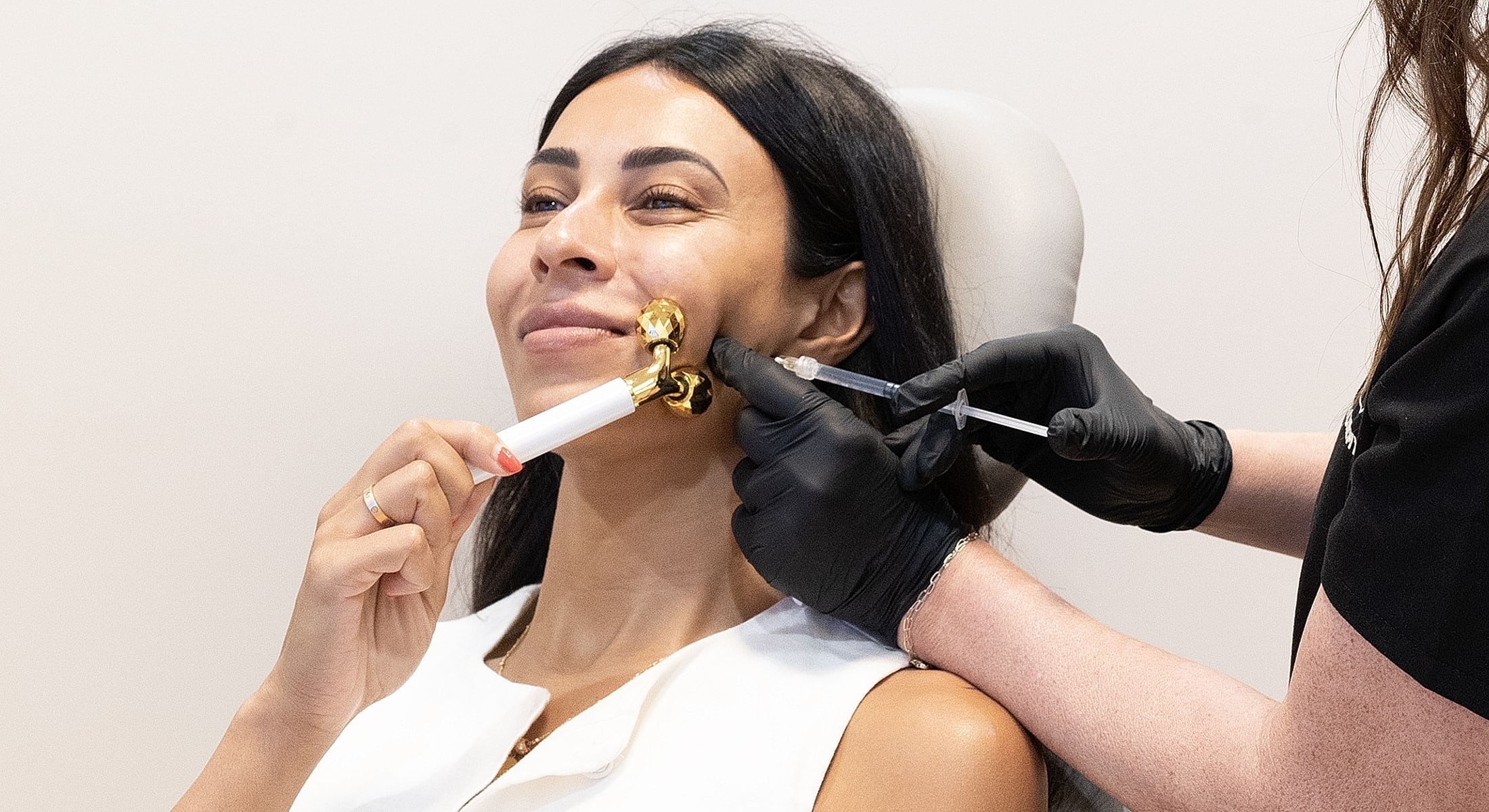 Woman receiving facial treatment at wellness clinic.