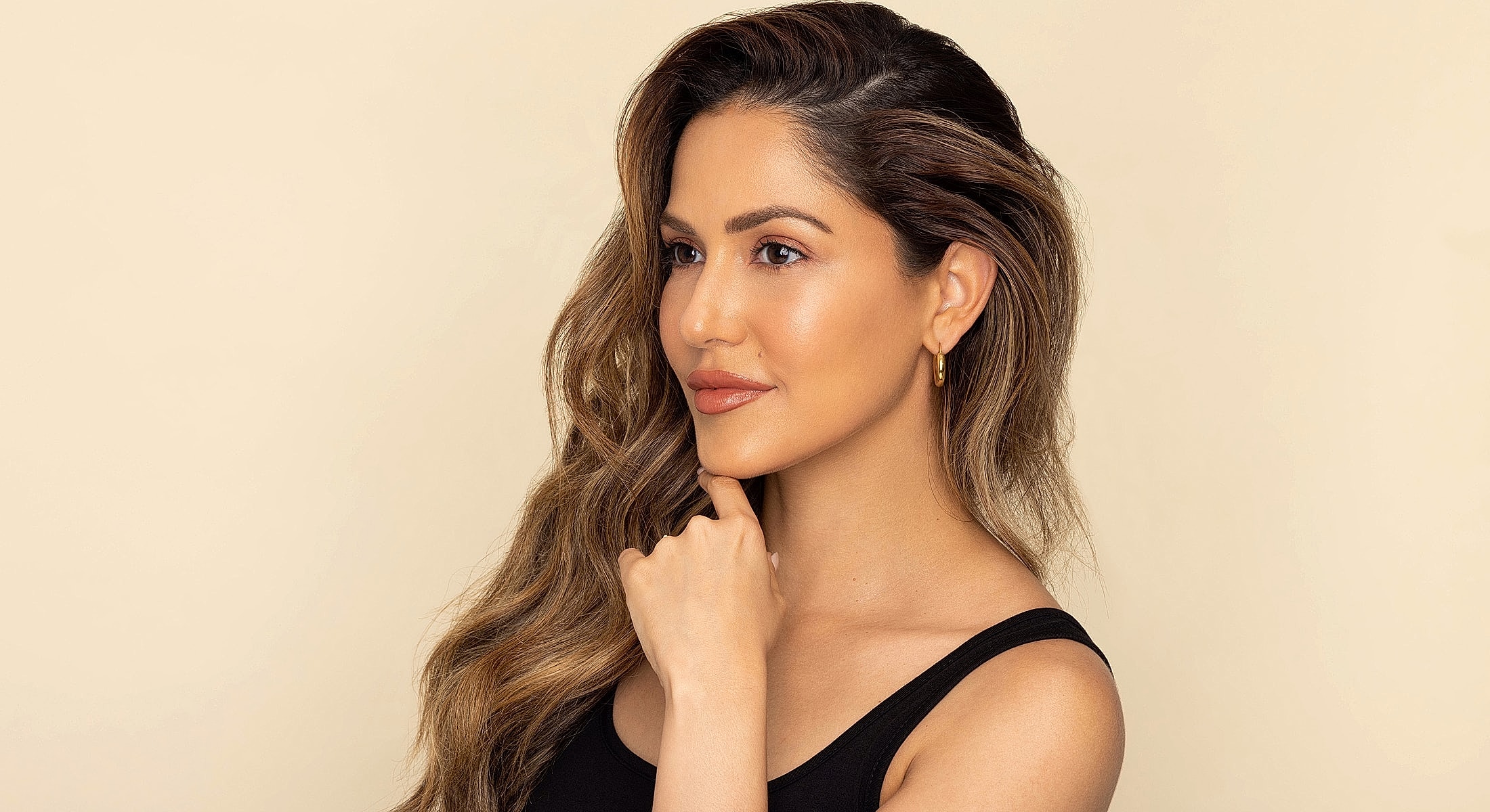 Profile of a woman with wavy hair.