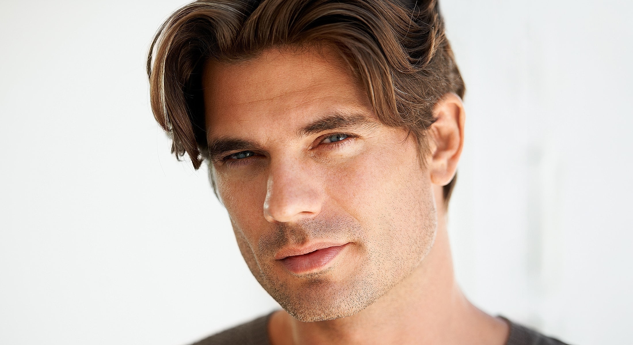 Close-up of a man with tousled hair.